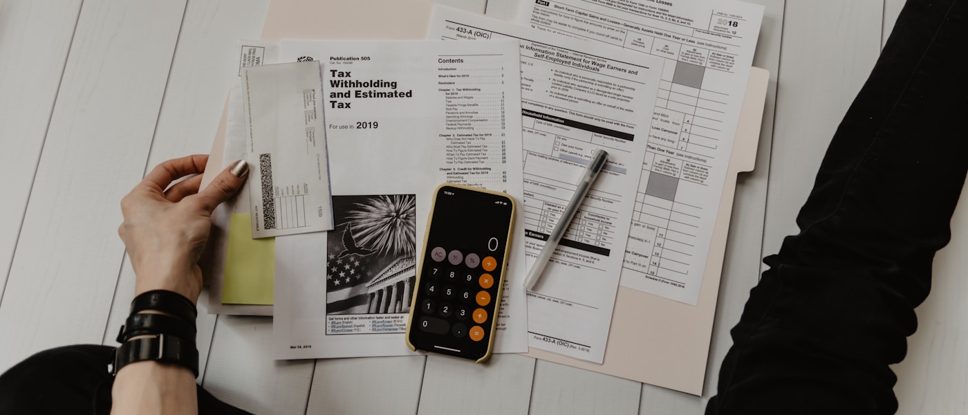 A calm financial planning session with notes, calculator and a warm cup of coffee