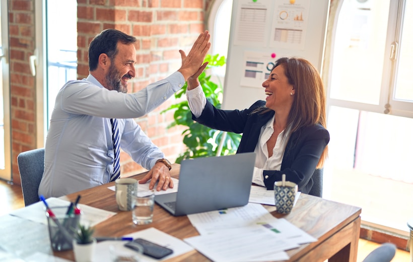 Two people reviewing a long-term financial plan together at a bright desk