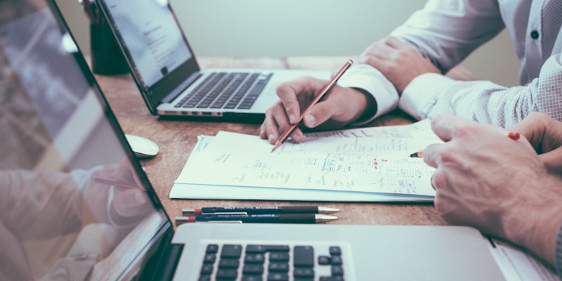 Long-term financial planning documents and charts on a desk